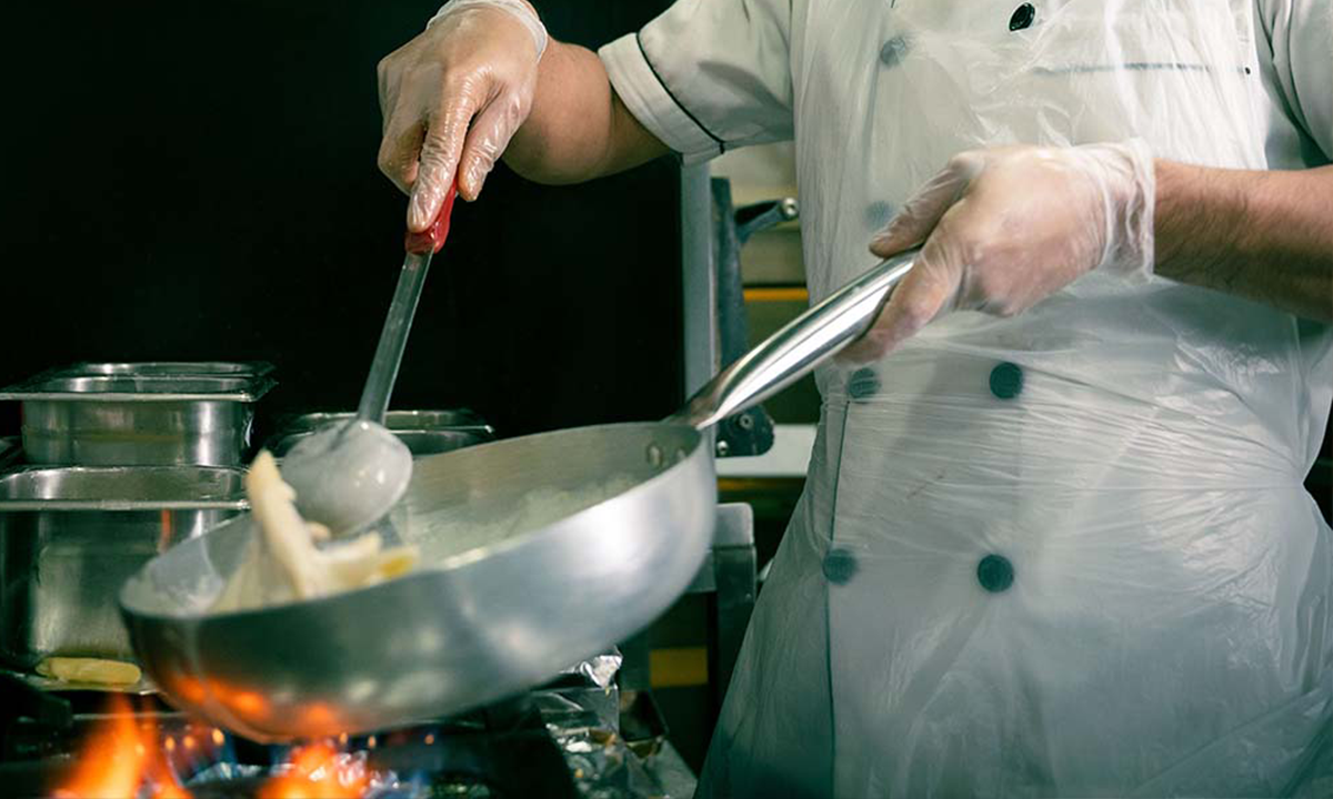 Chef preparing fresh Italian pizza in an Italian Restaurants in Muscat