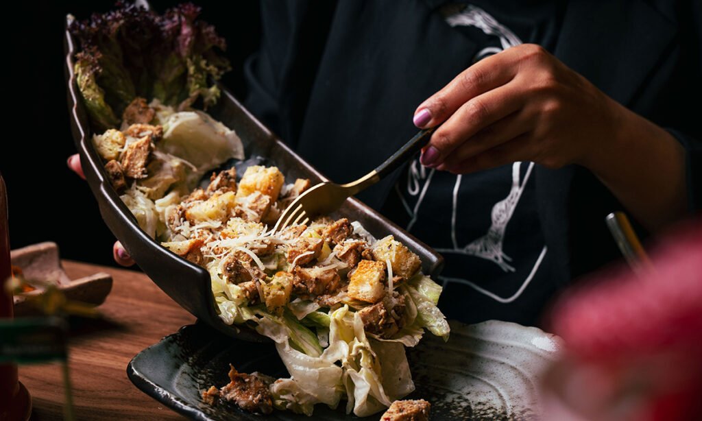 Fresh Chicken Caesar Salad with croutons and parmesan cheese served at an Italian restaurant