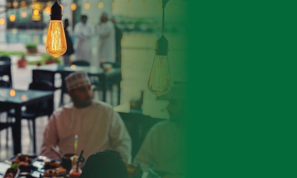 Cozy outdoor ambiance with Omani guests enjoying italian food at an Italian restaurant in Muscat